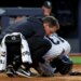 Yankees second baseman Jazz Chisholm Jr. being checked on by a trainer after fouling the ball off his groin.