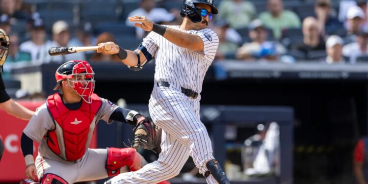 New York Yankees center fielder Trent Grisham (12) hits a RBI single driving home New York Yankees third baseman Amed Rosario (14) in the eighth inning against the Boston Red Sox at Yankee Stadium, Sunday, June 7, 2026, in Bronx, NY.