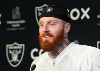Maxx Crosby speaking at a press conference.