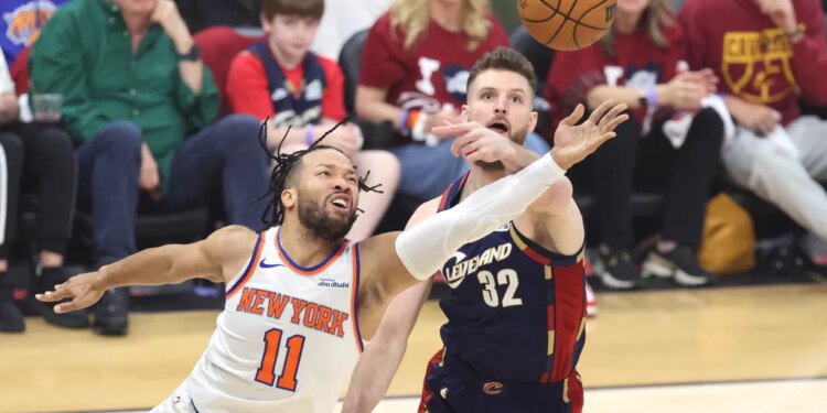 New York Knicks guard Jalen Brunson (11) shoots as Cleveland Cavaliers forward Dean Wade (32) defends during the first quarter.