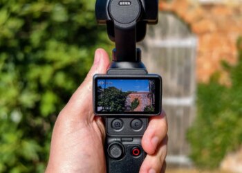 Photo of DJI Osmo Pocket 4P with a brick wall in the background.