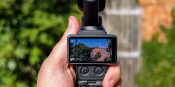 Photo of DJI Osmo Pocket 4P with a brick wall in the background.