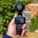 Photo of DJI Osmo Pocket 4P with a brick wall in the background.