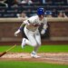New York Mets center fielder A.J. Ewing (9) hits a single against the Atlanta Braves.