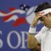 Kei Nishikori holding his head in his hand during a tennis match.