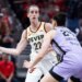 Indiana Fever guard Caitlin Clark (22) passes the ball while Golden State Valkyries forward Cecilia Zandalasini (24) defends.