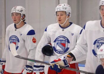 New York Rangers Development Camp players Drew Fortescue and Alberts Smits in white jerseys.