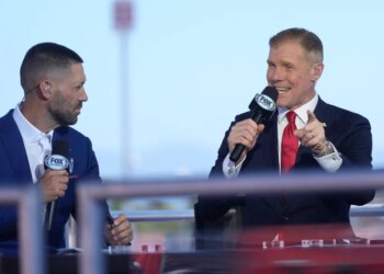 Fox Sports commentators Clint Dempsey and Alexi Lalas talking on set.