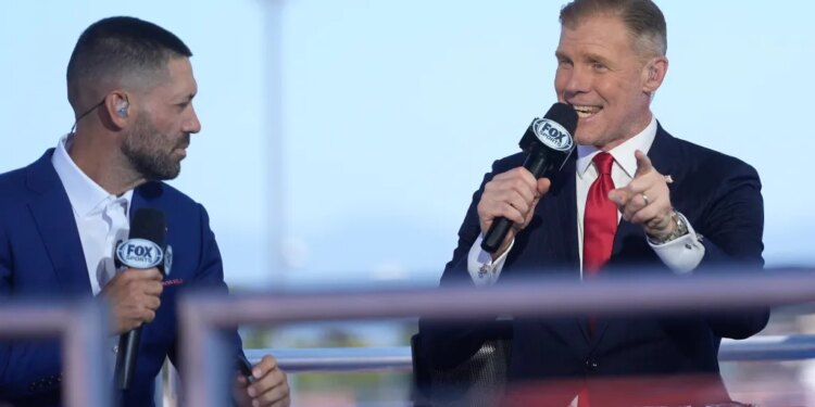 Fox Sports commentators Clint Dempsey and Alexi Lalas talking on set.