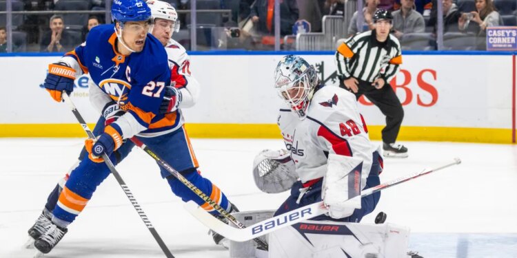 New York Islanders left wing Anders Lee (27) pressures Washington Capitals goaltender Logan Thompson (48) during the first period at UBS Arena.