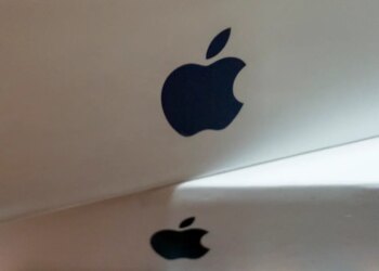 Close-up of a stack of white boxes, each with a dark gray Apple logo on the side.