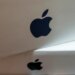 Close-up of a stack of white boxes, each with a dark gray Apple logo on the side.