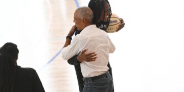 Former President Barack Obama embracing WNBA All-Star Jonquel Jones.