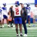 New York Giants cornerback Deonte Banks talking to head coach John Harbaugh during football practice.