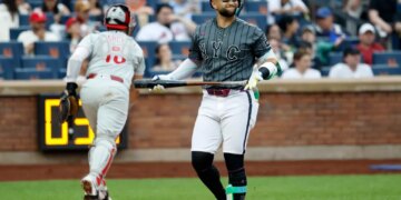 New York Mets shortstop Bo Bichette reacting after striking out swinging.
