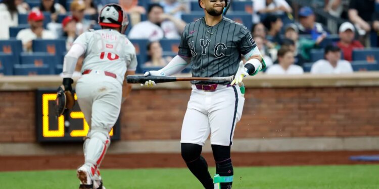 New York Mets shortstop Bo Bichette reacting after striking out swinging.