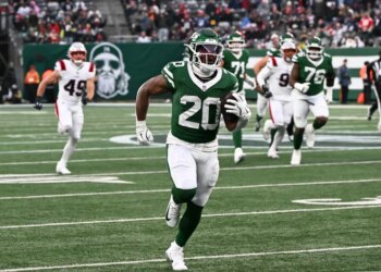 Jets running back Breece Hall (20) runs for a touchdown.
