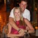 Niners quarterback Brock Purdy and his wife Jenna smile while sitting at a table with drinks.