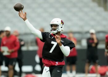 Arizona Cardinals quarterback Jacoby Brissett throwing a football during practice.