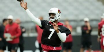 Arizona Cardinals quarterback Jacoby Brissett throwing a football during practice.