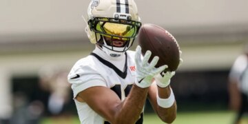 New Orleans Saints wide receiver Chris Olave catching a football during practice.