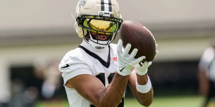 New Orleans Saints wide receiver Chris Olave catching a football during practice.