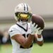 New Orleans Saints wide receiver Chris Olave catching a football during practice.