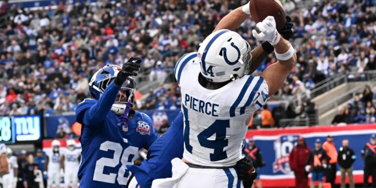 Indianapolis Colts wide receiver Alec Pierce (14) catches a touchdown pass against a Giants defender.