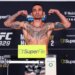 Max Holloway flexing on the scale during the UFC 329 weigh-in.