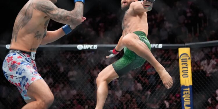 Conor McGregor attempts a flying kick on Max Holloway during their UFC fight.