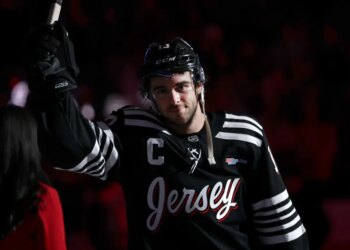 New Jersey Devils center Nico Hischier wearing a black jersey with "Jersey" written on it.