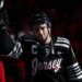 New Jersey Devils center Nico Hischier wearing a black jersey with "Jersey" written on it.