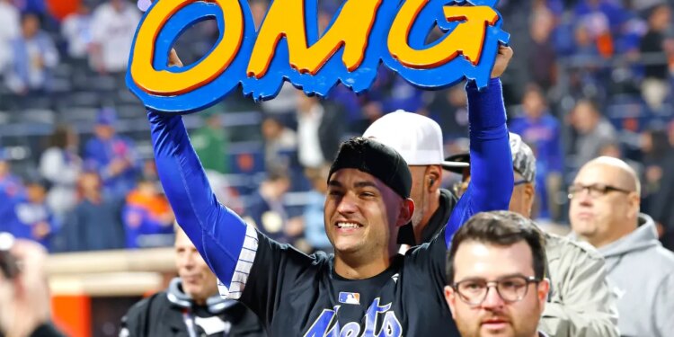 Jose Iglesias #11 of the New York Mets celebrates with an "OMG" sign after defeating the Philadelphia Phillies in Game 4 of the NLDS.