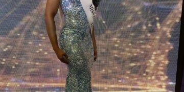 LaToya Malcolm in a sequined gown and a "Miss Universe Jamaica" sash.
