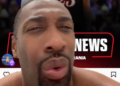 A man's face close up with a basketball player in a "76ers" jersey in the background.