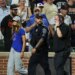 A fan is escorted off the field by police and security after entering the field during the ninth inning a baseball game between the Baltimore Orioles and the Chicago Cubs, Wednesday, July 8, 2026, in Baltimore.