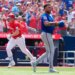 Toronto Blue Jays player Sean Keys runs the bases while New York Mets pitcher Freddy Peralta reacts in a baseball game.