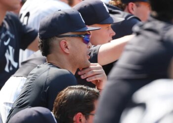 New York Yankees player Giancarlo Stanton in the dugout.