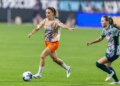 Gotham FC's Esther González dribbles the ball down the pitch as Washington Spirit's Gabrielle Carle chases her.