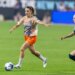Gotham FC's Esther González dribbles the ball down the pitch as Washington Spirit's Gabrielle Carle chases her.