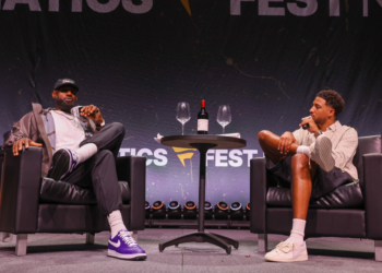 LeBron James and Tyrese Haliburton sitting in armchairs on stage at Fanatics Fest NYC.