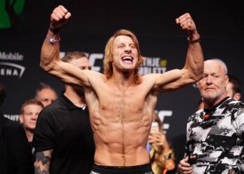Paddy Pimblett flexes his arms at the ceremonial weigh-in for UFC 324.