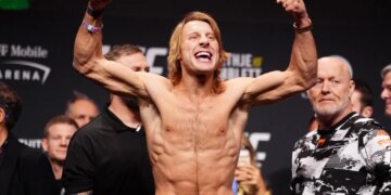 Paddy Pimblett flexes his arms at the ceremonial weigh-in for UFC 324.