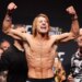 Paddy Pimblett flexes his arms at the ceremonial weigh-in for UFC 324.