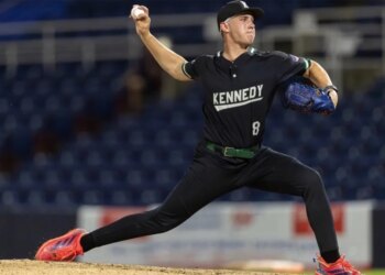 Derek Yormack pitching in his Kennedy High School uniform.