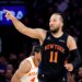 New York Knicks guard Jalen Brunson points while running during an NBA playoff game.