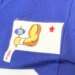 Giants patches, a hand holding a sign with "ny" on it and a red star, on a blue jersey.