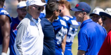 New York Giants owner John Mara speaking with head coach John Harbaugh during camp.