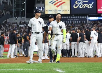 New York Yankees shortstop José Caballero is escorted off the field after a scuffle with Pittsburgh Pirates pitcher Dennis Santana.