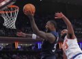 Julius Randle of the Minnesota Timberwolves shooting with Mitchell Robinson of the New York Knicks defending.